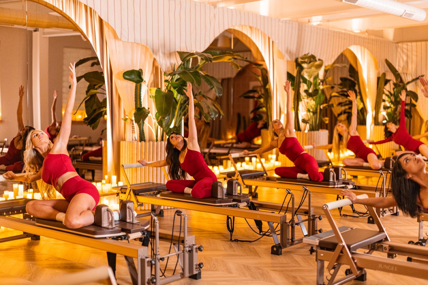 Bishop Reformer — group class in candle-lit arches